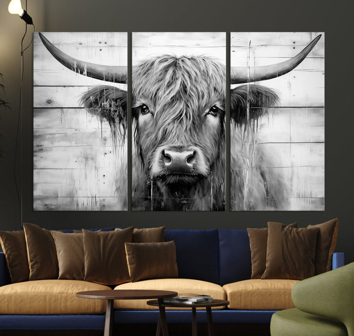 The Black White Highland Cow Wall Art Canvas Print, crafted on museum-quality canvases with a UV-protective coating, adds an elegant touch to the rustic wooden backdrop.