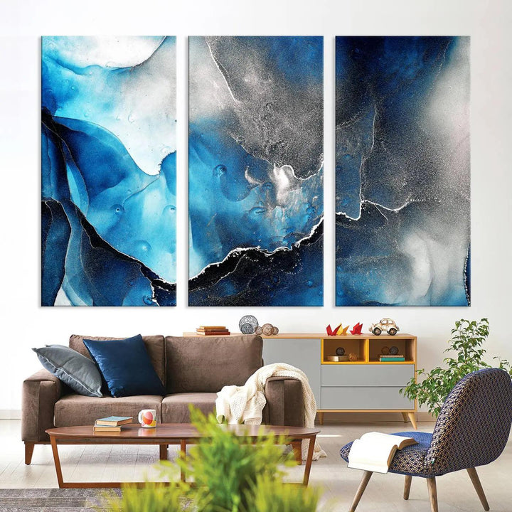 The Blue and Black Marble Fluid Effect Wall Art Abstract Canvas Prints feature three dynamic swirling patterns in blue, black, and white. Crafted on museum-quality canvases and enhanced with a UV-protective coating, these prints maintain their vibrant allure over time.