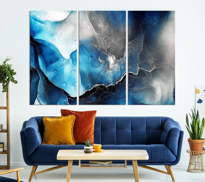 The Blue and Black Marble Fluid Effect Wall Art Abstract Canvas Prints feature three dynamic swirling patterns in blue, black, and white. Crafted on museum-quality canvases and enhanced with a UV-protective coating, these prints maintain their vibrant allure over time.