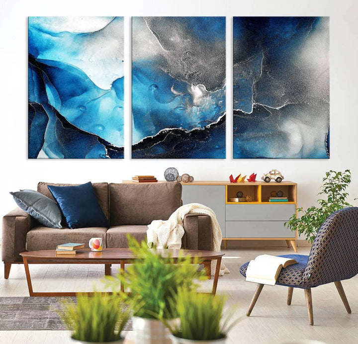 The Blue and Black Marble Fluid Effect Wall Art Abstract Canvas Prints feature three dynamic swirling patterns in blue, black, and white. Crafted on museum-quality canvases and enhanced with a UV-protective coating, these prints maintain their vibrant allure over time.