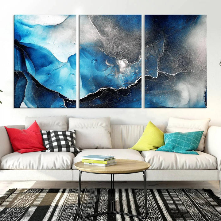 The Blue and Black Marble Fluid Effect Wall Art Abstract Canvas Prints feature three dynamic swirling patterns in blue, black, and white. Crafted on museum-quality canvases and enhanced with a UV-protective coating, these prints maintain their vibrant allure over time.