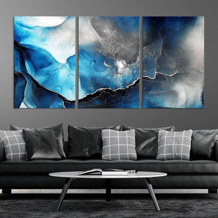 The Blue and Black Marble Fluid Effect Wall Art Abstract Canvas Prints feature three dynamic swirling patterns in blue, black, and white. Crafted on museum-quality canvases and enhanced with a UV-protective coating, these prints maintain their vibrant allure over time.