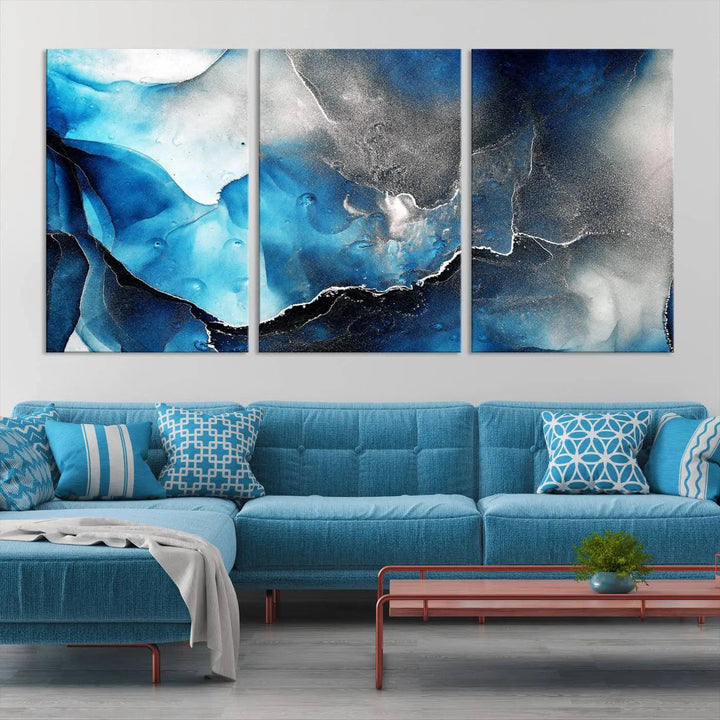 The Blue and Black Marble Fluid Effect Wall Art Abstract Canvas Prints feature three dynamic swirling patterns in blue, black, and white. Crafted on museum-quality canvases and enhanced with a UV-protective coating, these prints maintain their vibrant allure over time.