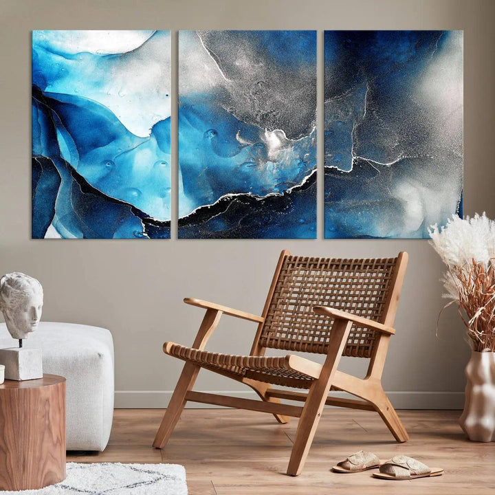 The Blue and Black Marble Fluid Effect Wall Art Abstract Canvas Prints feature three dynamic swirling patterns in blue, black, and white. Crafted on museum-quality canvases and enhanced with a UV-protective coating, these prints maintain their vibrant allure over time.