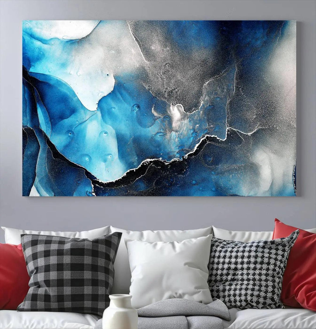 The Blue and Black Marble Fluid Effect Wall Art Abstract Canvas Prints feature three dynamic swirling patterns in blue, black, and white. Crafted on museum-quality canvases and enhanced with a UV-protective coating, these prints maintain their vibrant allure over time.