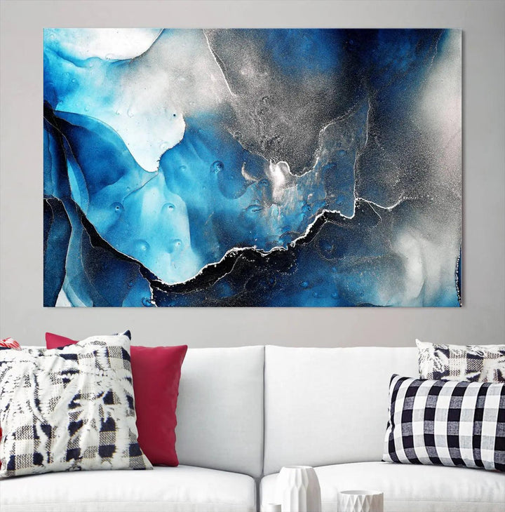 The Blue and Black Marble Fluid Effect Wall Art Abstract Canvas Prints feature three dynamic swirling patterns in blue, black, and white. Crafted on museum-quality canvases and enhanced with a UV-protective coating, these prints maintain their vibrant allure over time.