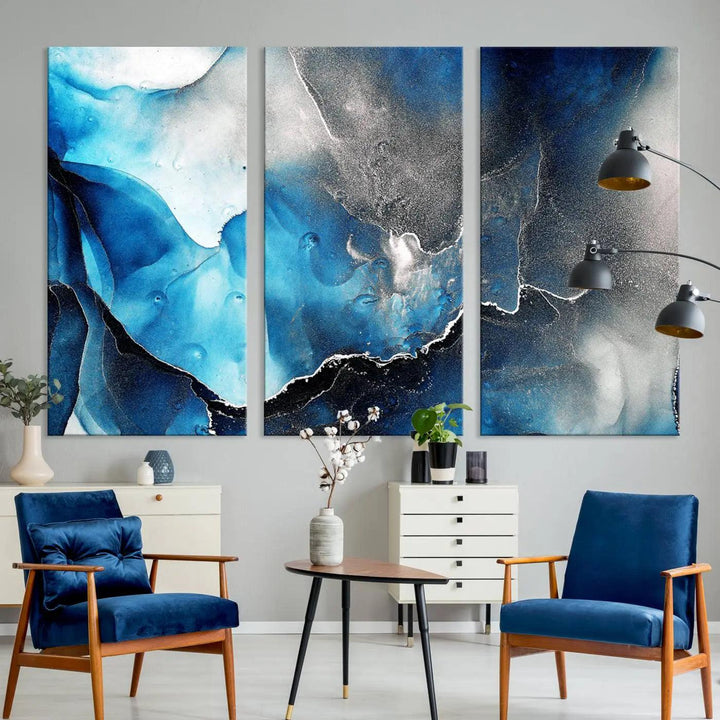 The Blue and Black Marble Fluid Effect Wall Art Abstract Canvas Prints feature three dynamic swirling patterns in blue, black, and white. Crafted on museum-quality canvases and enhanced with a UV-protective coating, these prints maintain their vibrant allure over time.