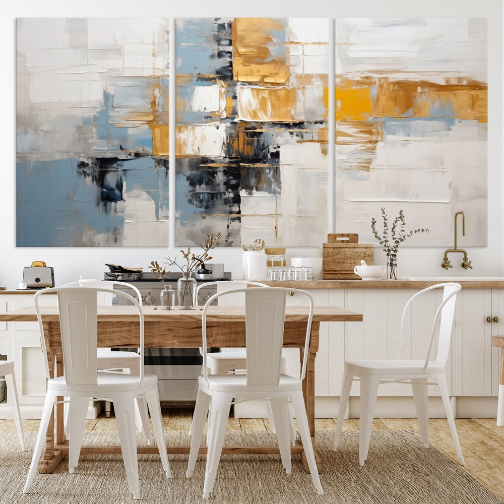 A stunning triptych of the Blue Orange Abstract Wall Art Canvas Print adorns the wall. These gallery-wrapped abstract pieces, showcasing blue, yellow, and white tones, feature a UV-protective coating to maintain their vivid colors.