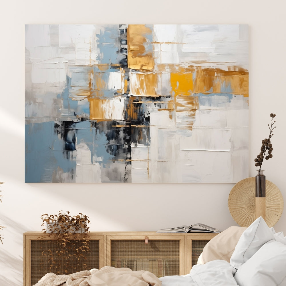 A stunning triptych of the Blue Orange Abstract Wall Art Canvas Print adorns the wall. These gallery-wrapped abstract pieces, showcasing blue, yellow, and white tones, feature a UV-protective coating to maintain their vivid colors.