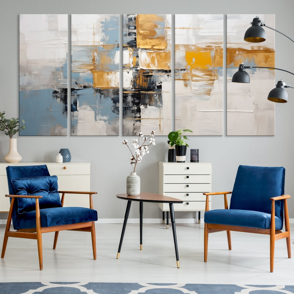 A stunning triptych of the Blue Orange Abstract Wall Art Canvas Print adorns the wall. These gallery-wrapped abstract pieces, showcasing blue, yellow, and white tones, feature a UV-protective coating to maintain their vivid colors.