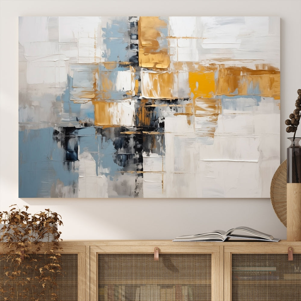 A stunning triptych of the Blue Orange Abstract Wall Art Canvas Print adorns the wall. These gallery-wrapped abstract pieces, showcasing blue, yellow, and white tones, feature a UV-protective coating to maintain their vivid colors.