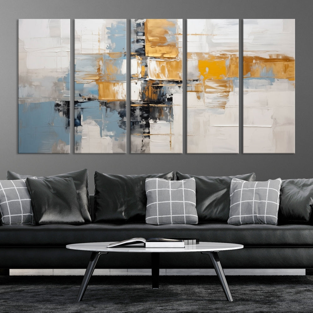 A stunning triptych of the Blue Orange Abstract Wall Art Canvas Print adorns the wall. These gallery-wrapped abstract pieces, showcasing blue, yellow, and white tones, feature a UV-protective coating to maintain their vivid colors.