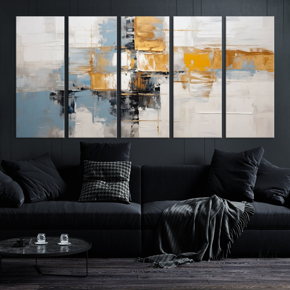 A stunning triptych of the Blue Orange Abstract Wall Art Canvas Print adorns the wall. These gallery-wrapped abstract pieces, showcasing blue, yellow, and white tones, feature a UV-protective coating to maintain their vivid colors.