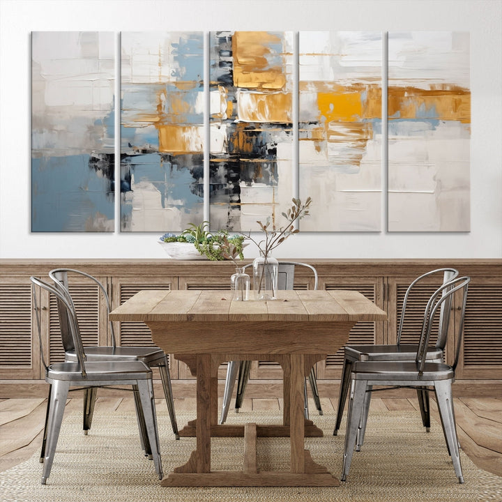 A stunning triptych of the Blue Orange Abstract Wall Art Canvas Print adorns the wall. These gallery-wrapped abstract pieces, showcasing blue, yellow, and white tones, feature a UV-protective coating to maintain their vivid colors.