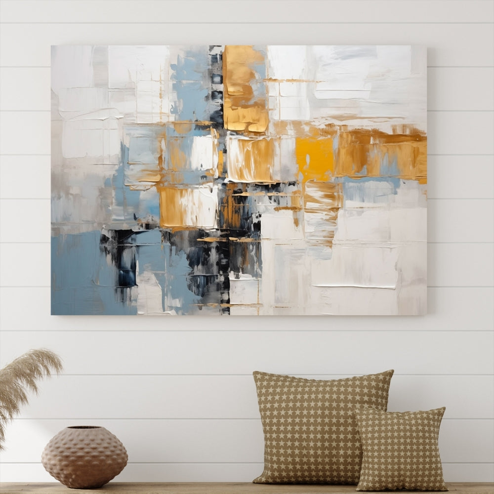 A stunning triptych of the Blue Orange Abstract Wall Art Canvas Print adorns the wall. These gallery-wrapped abstract pieces, showcasing blue, yellow, and white tones, feature a UV-protective coating to maintain their vivid colors.