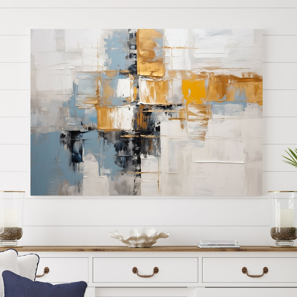 A stunning triptych of the Blue Orange Abstract Wall Art Canvas Print adorns the wall. These gallery-wrapped abstract pieces, showcasing blue, yellow, and white tones, feature a UV-protective coating to maintain their vivid colors.