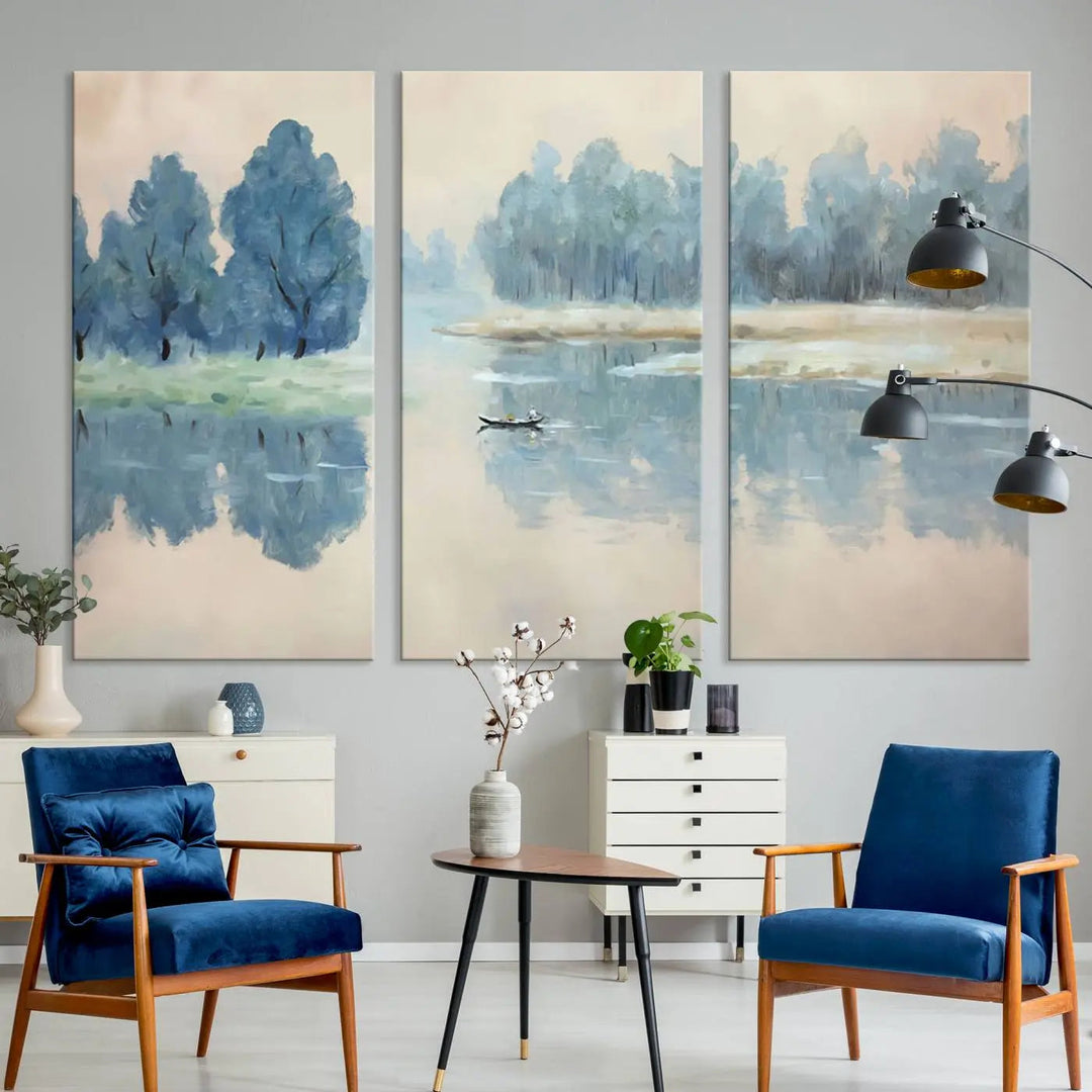 The triptych canvas print, "Blue Trees and Water Reflection Landscape," showcases a serene lake and boat scene through giclee printing. The blue trees reflecting on the water create a calming ambiance, making it an ideal choice for nature lovers.