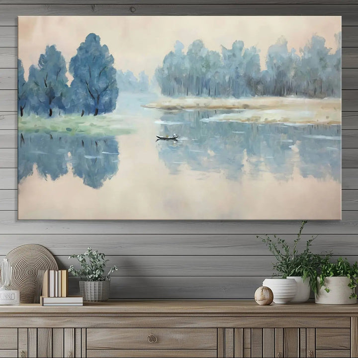 The triptych canvas print, "Blue Trees and Water Reflection Landscape," showcases a serene lake and boat scene through giclee printing. The blue trees reflecting on the water create a calming ambiance, making it an ideal choice for nature lovers.