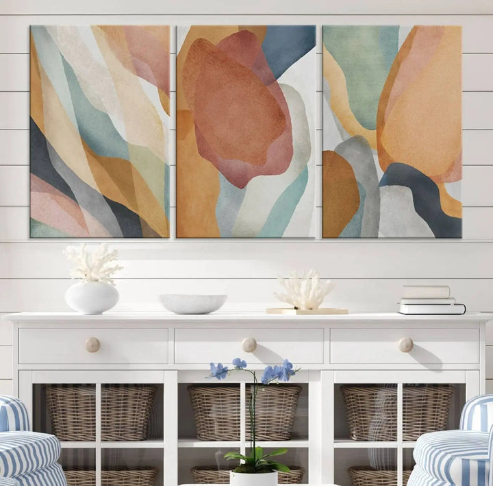 The Boho Wall Art Canvas Print Set, featuring warm hues in an abstract triptych, is presented on museum-quality canvas.