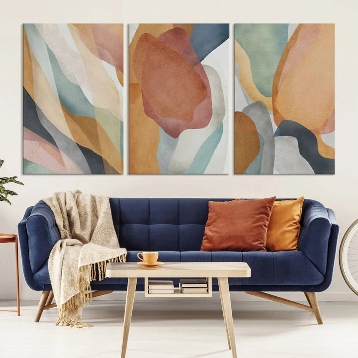 The Boho Wall Art Canvas Print Set, featuring warm hues in an abstract triptych, is presented on museum-quality canvas.