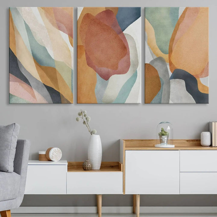 The Boho Wall Art Canvas Print Set, featuring warm hues in an abstract triptych, is presented on museum-quality canvas.