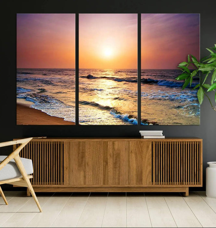 A cozy living room features the breathtaking California Coastline Sunset Canvas Art, capturing ocean waves crashing on cliffs to create the perfect coastal ambiance.