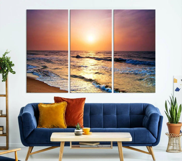 A cozy living room features the breathtaking California Coastline Sunset Canvas Art, capturing ocean waves crashing on cliffs to create the perfect coastal ambiance.