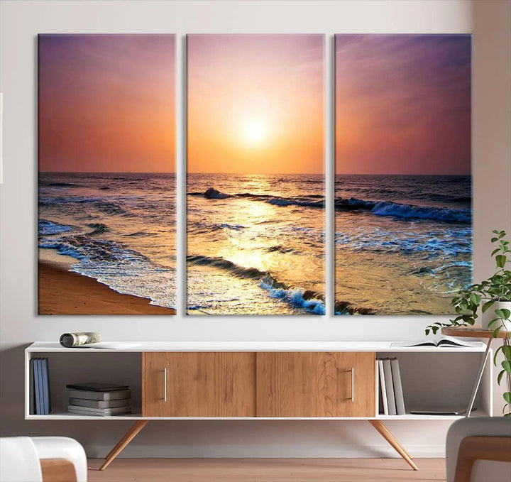 A cozy living room features the breathtaking California Coastline Sunset Canvas Art, capturing ocean waves crashing on cliffs to create the perfect coastal ambiance.