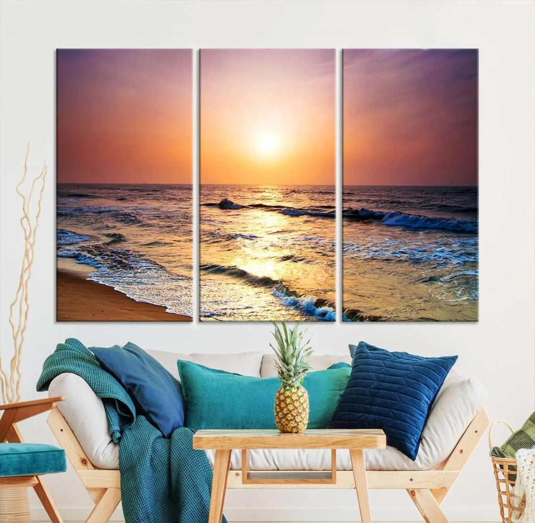 A cozy living room features the breathtaking California Coastline Sunset Canvas Art, capturing ocean waves crashing on cliffs to create the perfect coastal ambiance.