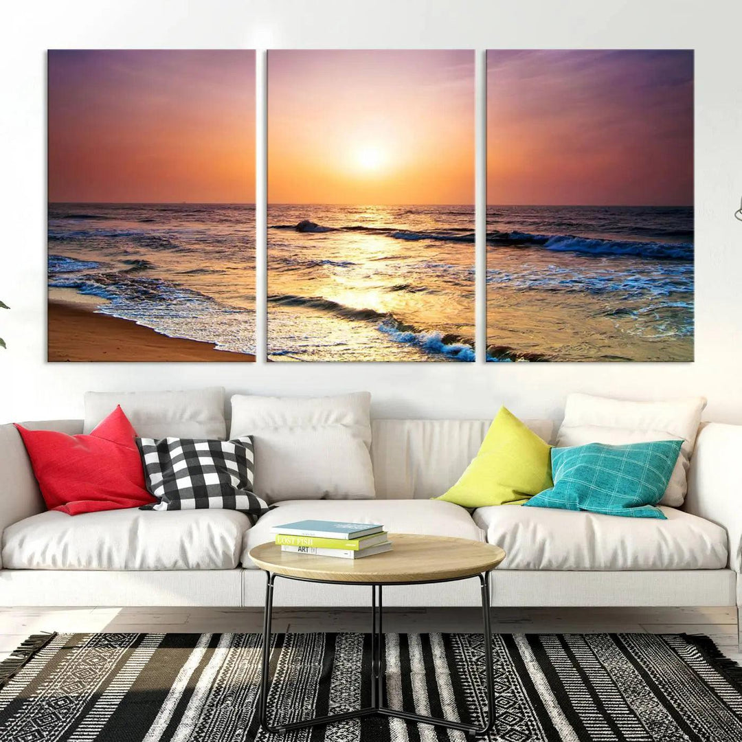 A cozy living room features the breathtaking California Coastline Sunset Canvas Art, capturing ocean waves crashing on cliffs to create the perfect coastal ambiance.