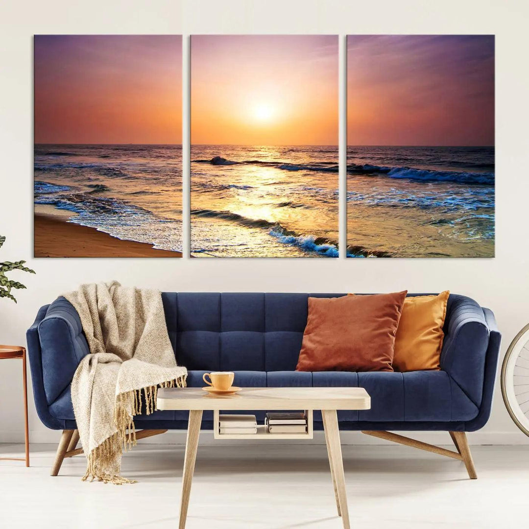 A cozy living room features the breathtaking California Coastline Sunset Canvas Art, capturing ocean waves crashing on cliffs to create the perfect coastal ambiance.