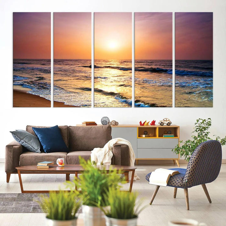 A cozy living room features the breathtaking California Coastline Sunset Canvas Art, capturing ocean waves crashing on cliffs to create the perfect coastal ambiance.