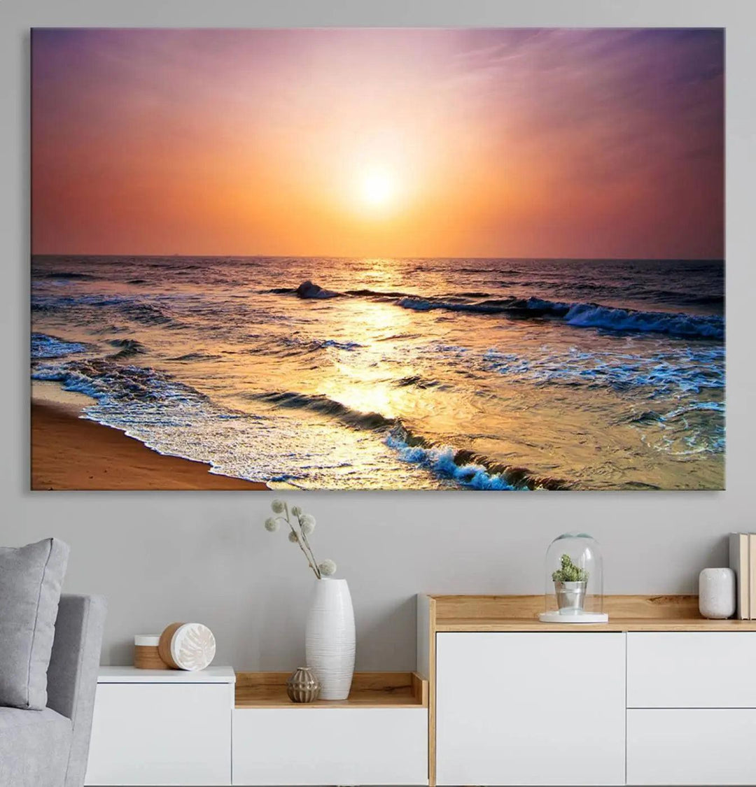 A cozy living room features the breathtaking California Coastline Sunset Canvas Art, capturing ocean waves crashing on cliffs to create the perfect coastal ambiance.