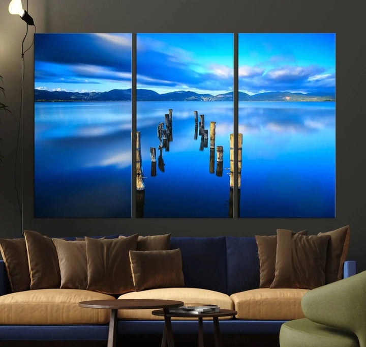 The Calm Waters Lake Canvas Art, featuring a tranquil pier reflection set against a mountainous backdrop, showcases its elegance with a gallery wrap and Canon print quality.