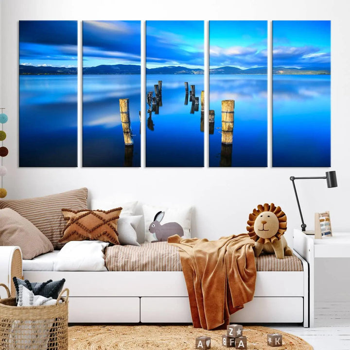 The Calm Waters Lake Canvas Art, featuring a tranquil pier reflection set against a mountainous backdrop, showcases its elegance with a gallery wrap and Canon print quality.