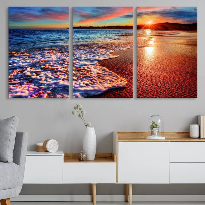 A captivating multi-panel seascape wall art showcases the Colorful Coastal Sunset on the Beach Canvas Print, depicting ocean waves crashing at dusk.