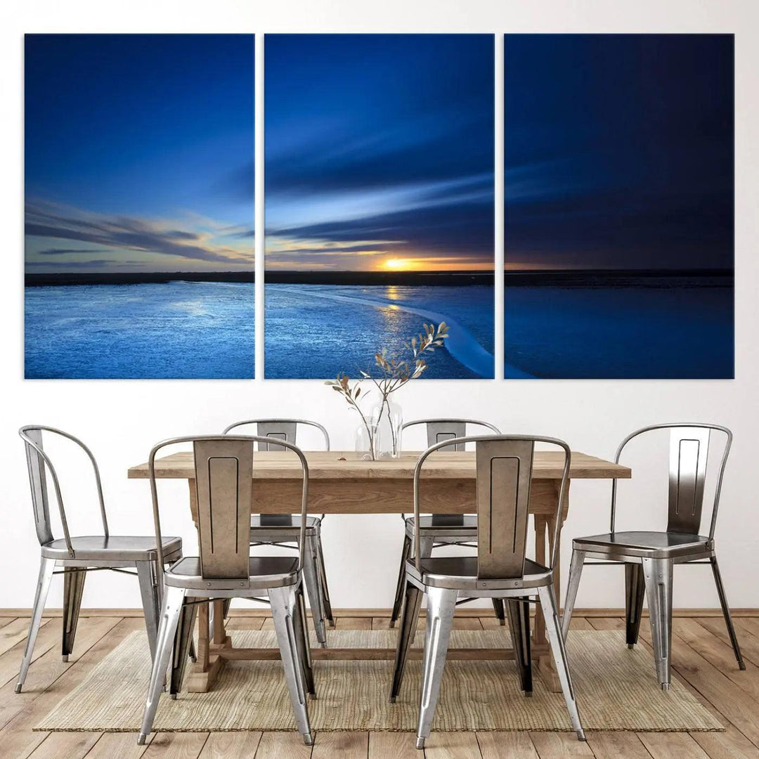 The serene living room is highlighted by the Deep Blue Ocean Sunset Triptych Canvas Art—a striking and serene coastal sunset print featuring an ocean horizon and sunset theme—commanding attention on the wall.