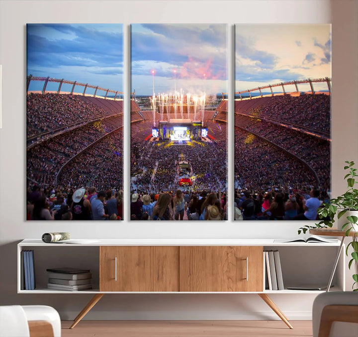 The Denver Broncos Football Team Print of Empower Field at Mile High Stadium adorns the wall, capturing a vibrant concert scene in a packed stadium at sunset with fireworks bursting above. This premium canvas offers an exquisite gallery-quality finish that perfectly complements the lively atmosphere.