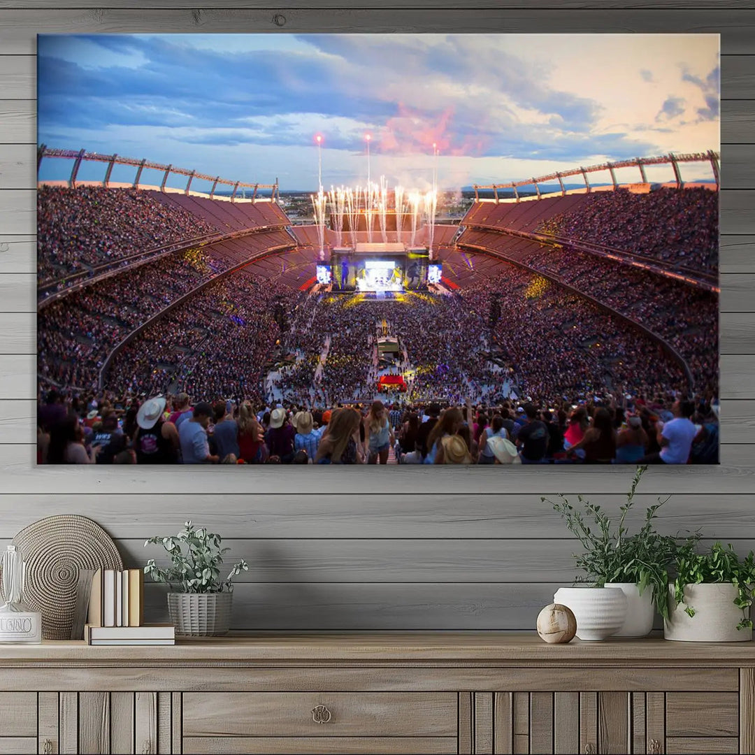 The Denver Broncos Football Team Print of Empower Field at Mile High Stadium adorns the wall, capturing a vibrant concert scene in a packed stadium at sunset with fireworks bursting above. This premium canvas offers an exquisite gallery-quality finish that perfectly complements the lively atmosphere.