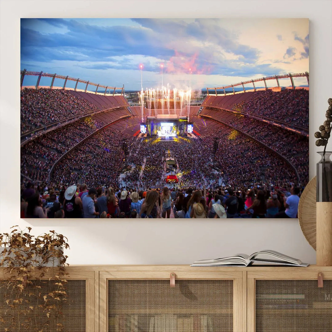 The Denver Broncos Football Team Print of Empower Field at Mile High Stadium adorns the wall, capturing a vibrant concert scene in a packed stadium at sunset with fireworks bursting above. This premium canvas offers an exquisite gallery-quality finish that perfectly complements the lively atmosphere.