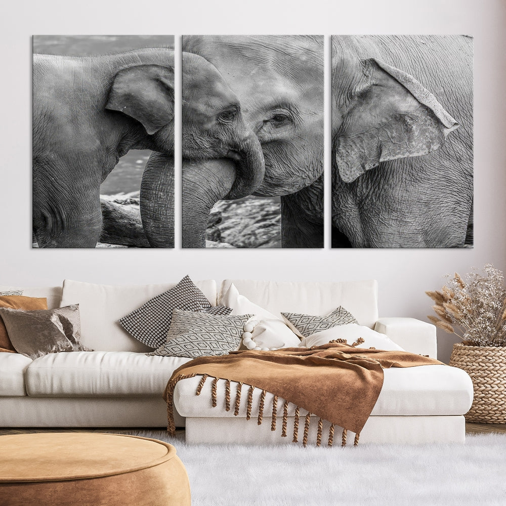 The Elephant Family Wall Art Canvas Print, depicting a black and white triptych of elephants embracing, is a museum-quality piece meticulously hand-assembled into framed art. This elegant canvas combines sophistication with the convenience of free shipping.