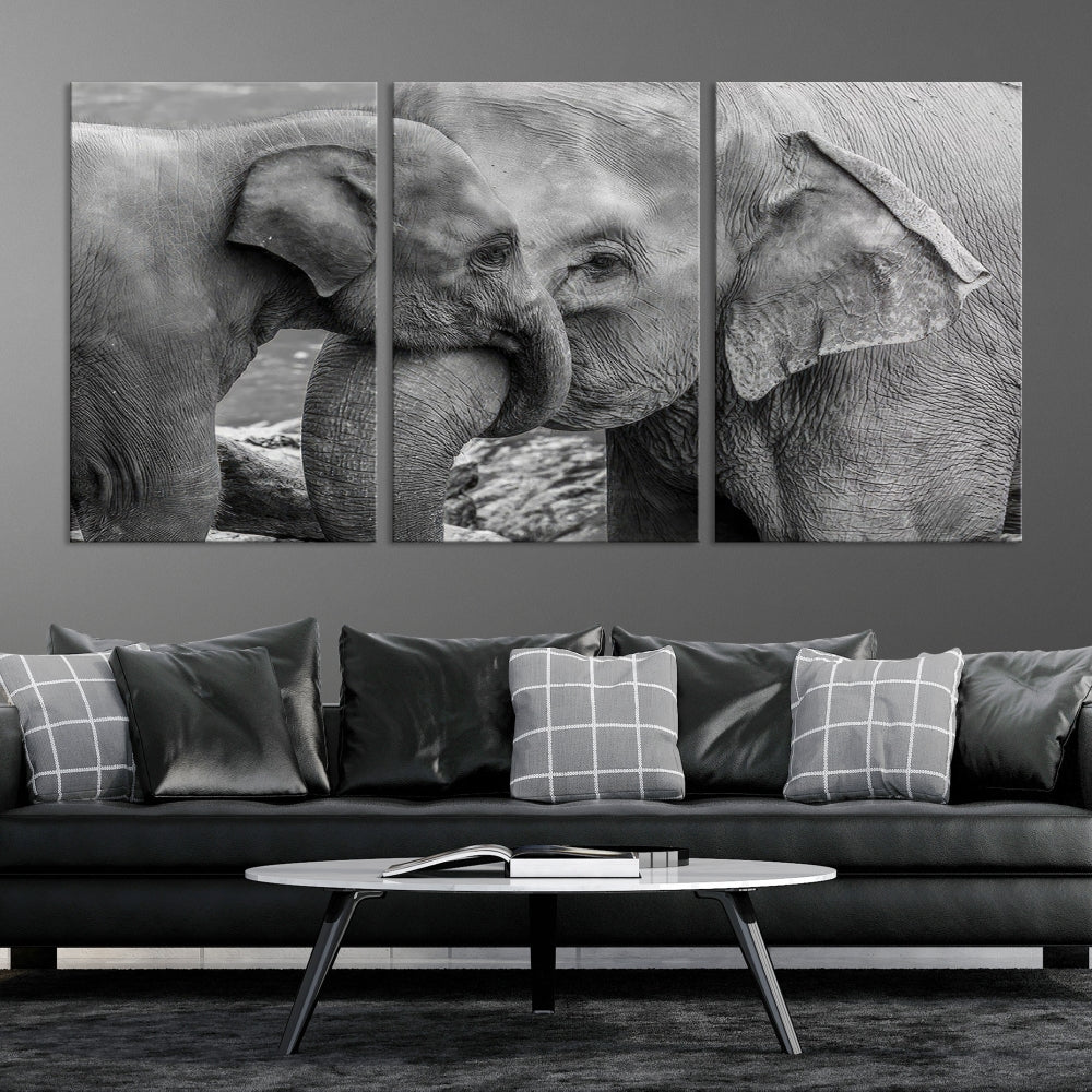 The Elephant Family Wall Art Canvas Print, depicting a black and white triptych of elephants embracing, is a museum-quality piece meticulously hand-assembled into framed art. This elegant canvas combines sophistication with the convenience of free shipping.