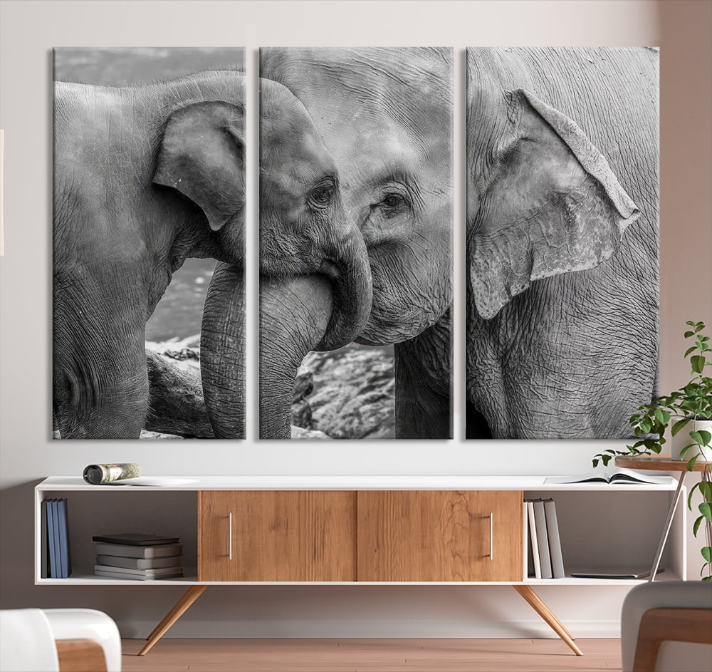 The Elephant Family Wall Art Canvas Print, depicting a black and white triptych of elephants embracing, is a museum-quality piece meticulously hand-assembled into framed art. This elegant canvas combines sophistication with the convenience of free shipping.