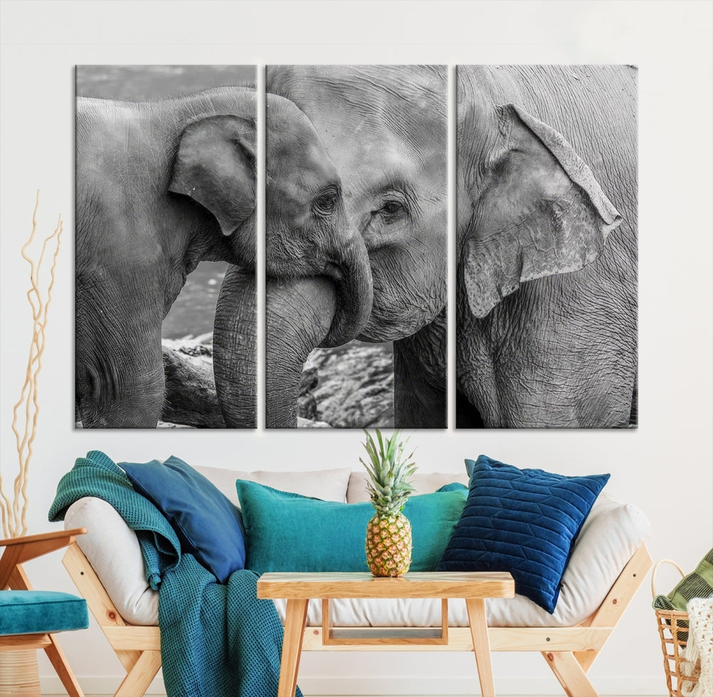 The Elephant Family Wall Art Canvas Print, depicting a black and white triptych of elephants embracing, is a museum-quality piece meticulously hand-assembled into framed art. This elegant canvas combines sophistication with the convenience of free shipping.