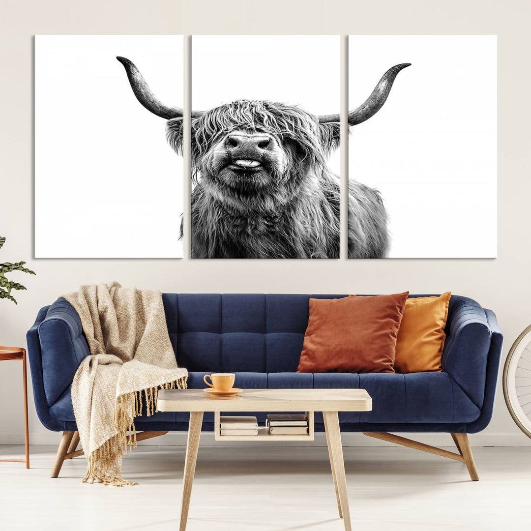 The living room features the Fanny Scottish Highland Cow Cattle Art Print Farmhouse Wall Art Canvas Print, a three-panel museum-quality artwork displayed against a dark wall.