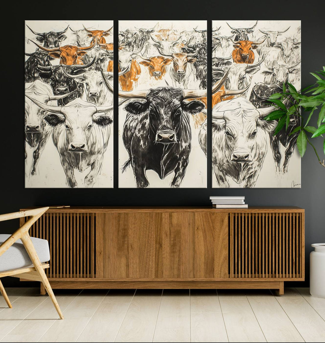 This exquisite farmhouse wall art, titled "Western Longhorn Cattle Canvas Print," showcases a majestic herd of longhorn cattle in a three-panel design. This ready-to-hang and framed barn decor infuses your space with rustic charm.