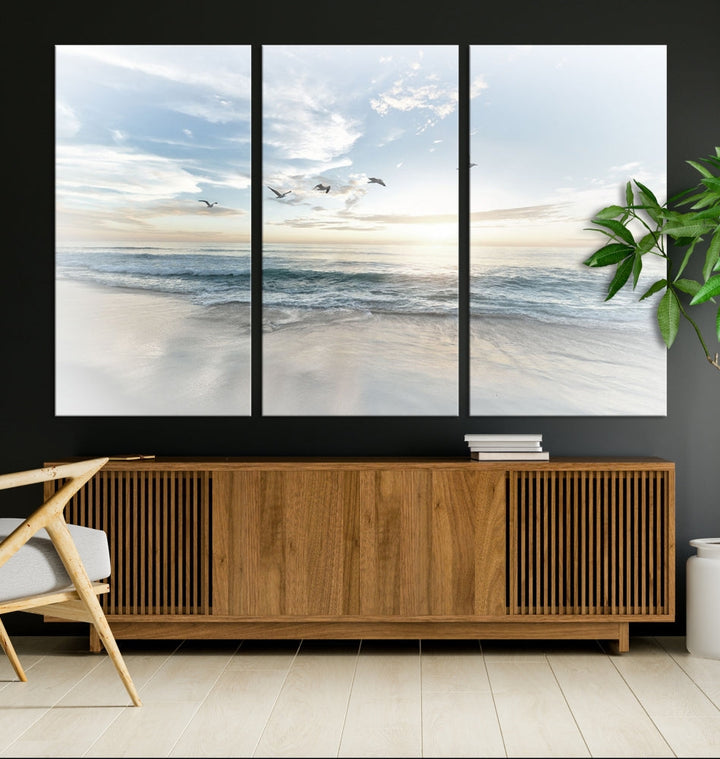 The Flight Over Coastal Beach Landscape Photography Print, a triptych of a serene ocean and sky scene with seagulls on museum-quality canvas, captivates as it hangs prominently in any space. Enjoy free shipping on this captivating piece that transforms any room into a tranquil retreat.