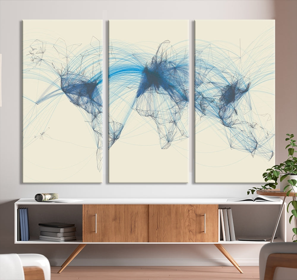 The Flight Routes Map art, featuring an abstract world map with blue connections representing global networks, is a three-panel canvas wall art piece.