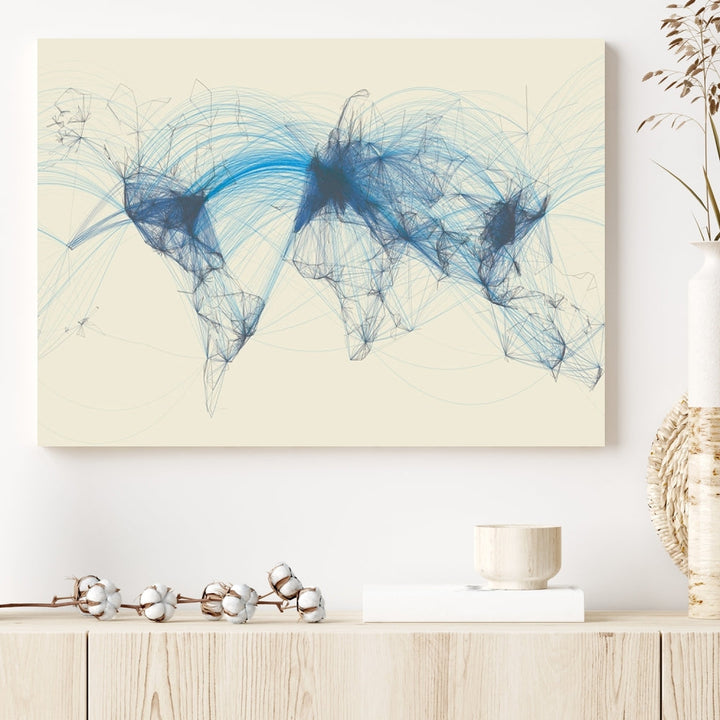 The Flight Routes Map art, featuring an abstract world map with blue connections representing global networks, is a three-panel canvas wall art piece.