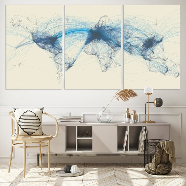 The Flight Routes Map art, featuring an abstract world map with blue connections representing global networks, is a three-panel canvas wall art piece.